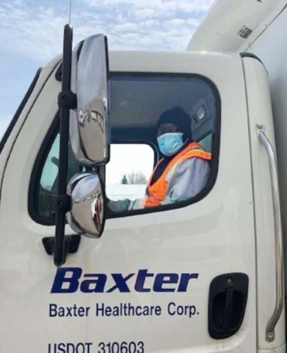 Image of a Baxter driver seated in a delivery truck